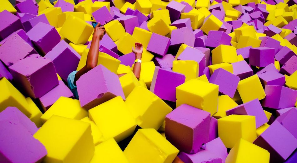 Cropped image of man amidst stack of sponges