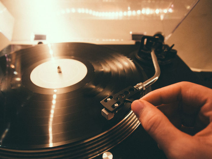 Cropped image of person plying turntable