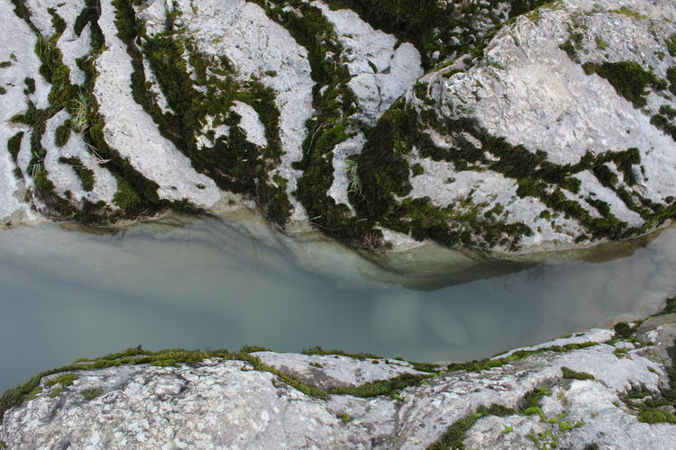 High angle view of rocks by lake