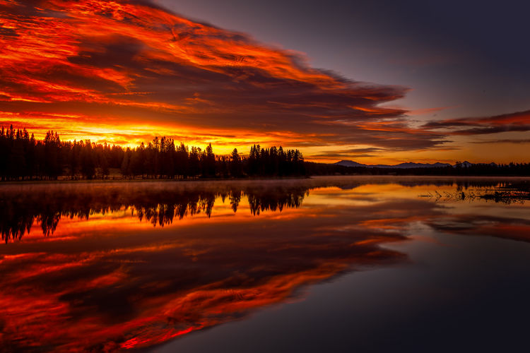 Burning sky, sunrise at the lake. yellowstone national park