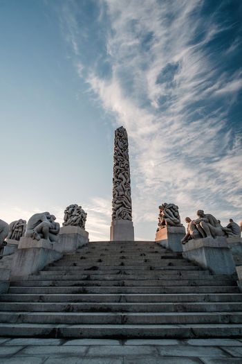 Low angle view of monument against cloudy sky
