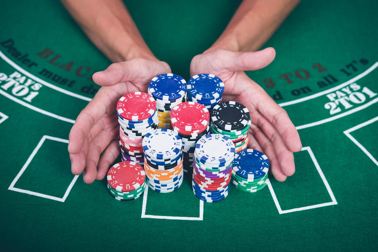 Cropped image of man with gambling chips at casino