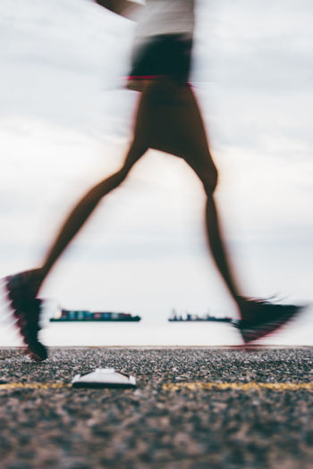 Low section of man running on road