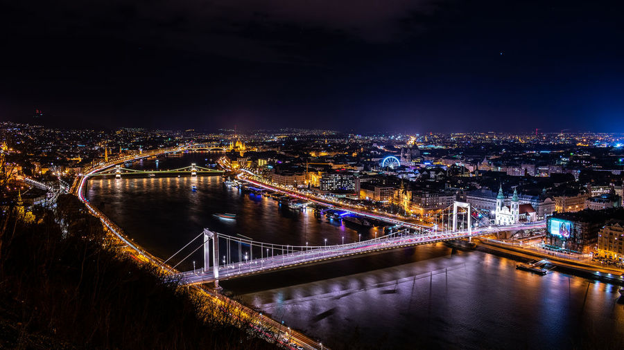 Illuminated bridge over river at night in budapest