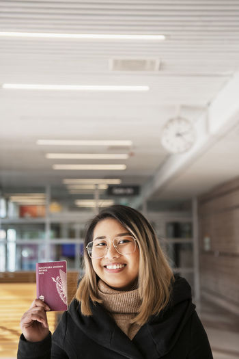 Smiling woman holding passport