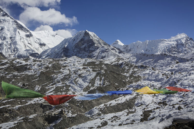 Island peak seen past prayer flags in nepal's khumbu valley.