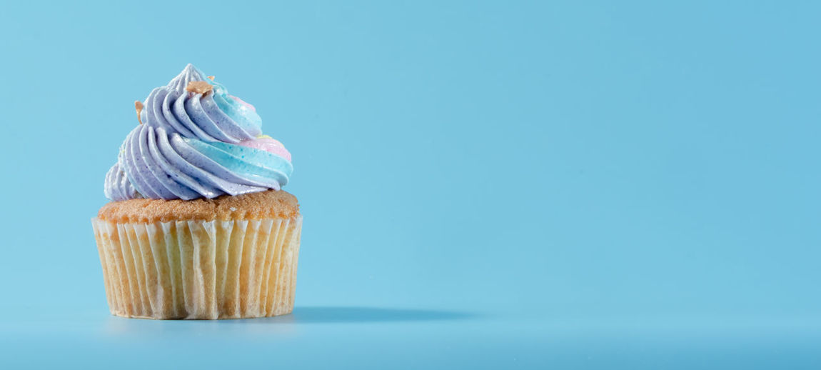 Close-up of cupcakes against blue background