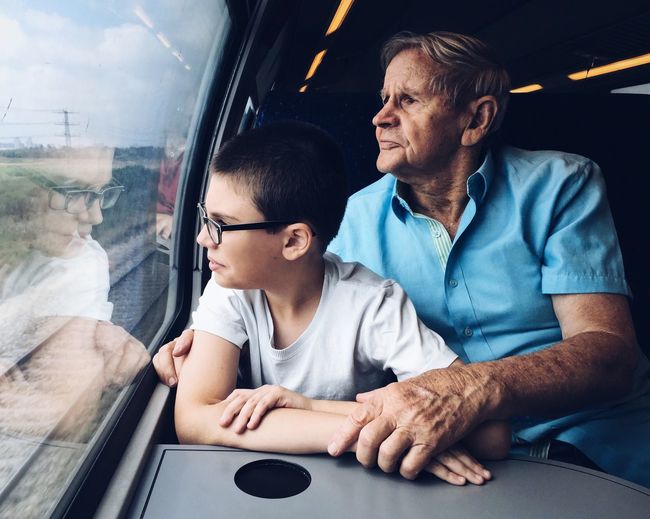 Man and child traveling by train