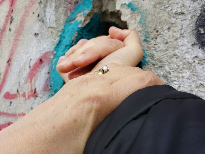 Cropped image of hands against wall