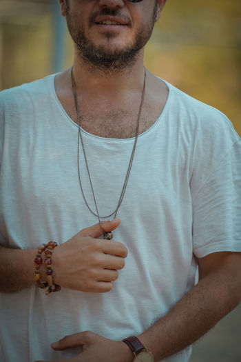 Midsection of man standing against the wall