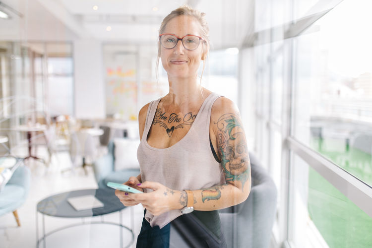 One Person Front View Women Glasses Focus On Foreground Wireless Technology Eyeglasses Communication Adult Connection Portrait Standing Holding Technology Day Mobile Phone Looking At Camera Smiling Hair Hairstyle Outdoors Beautiful Woman
