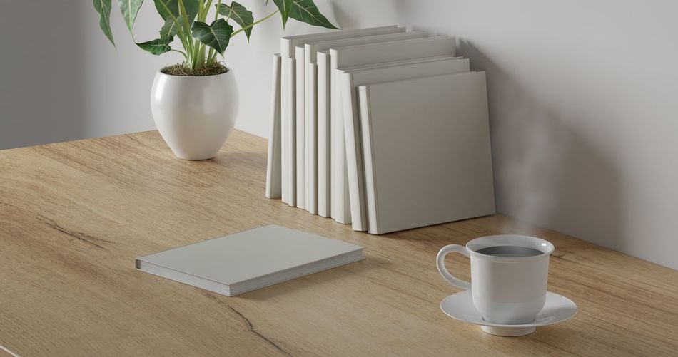 Coffee cup and potted plant on table