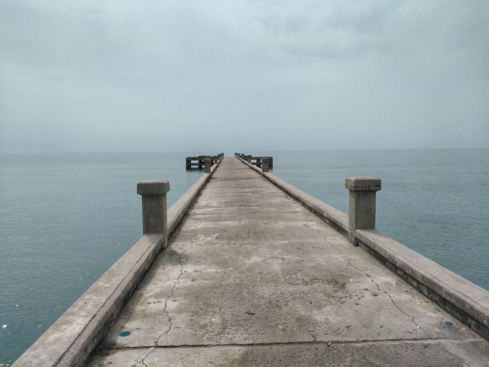 Pier over sea against sky