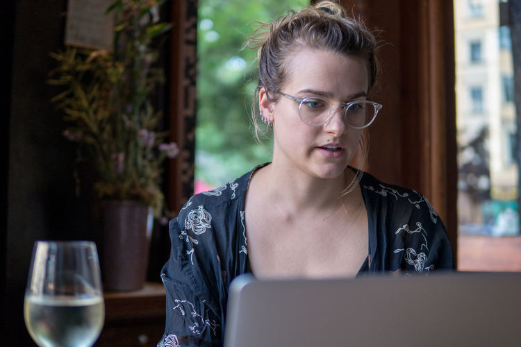 Portrait of a young woman using laptop