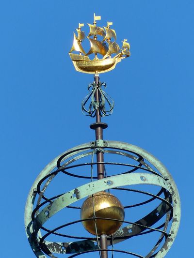 Low angle view of electric lamp against clear blue sky