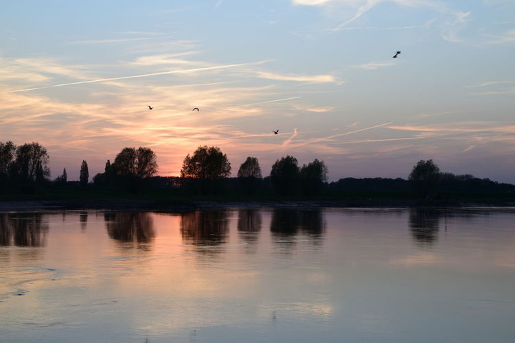 Scenic view of lake against sky during sunset