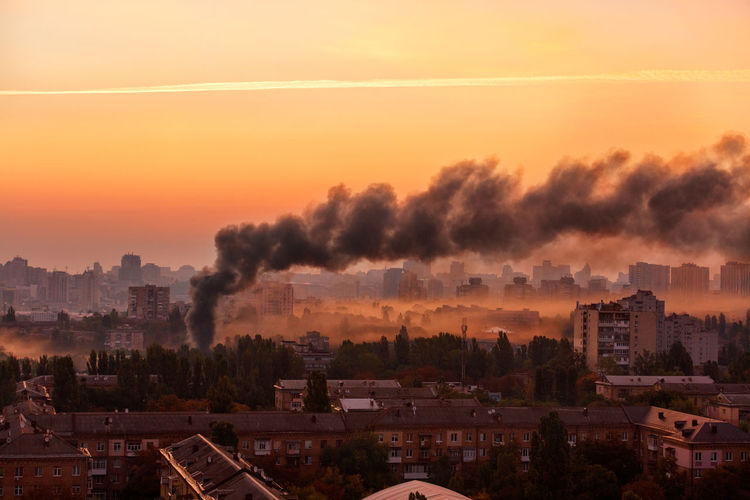 Early morning cityscape with black smoke from the conflagration.
