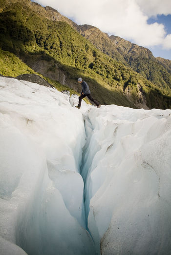 Man walking on glacier