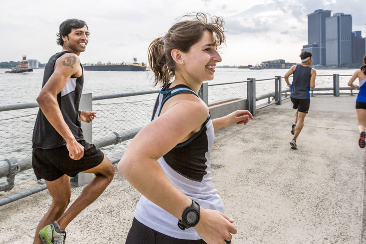 Group of runners training on waterfront in brooklyn bridge park