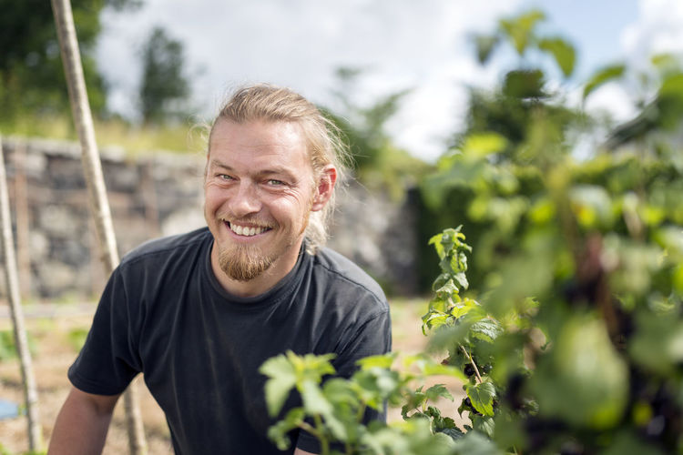 Portrait of smiling man against plants