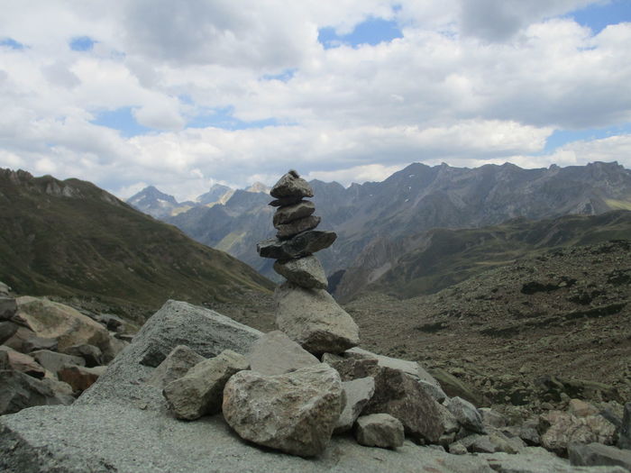 Stack of rocks at pyrenees against cloudy sky