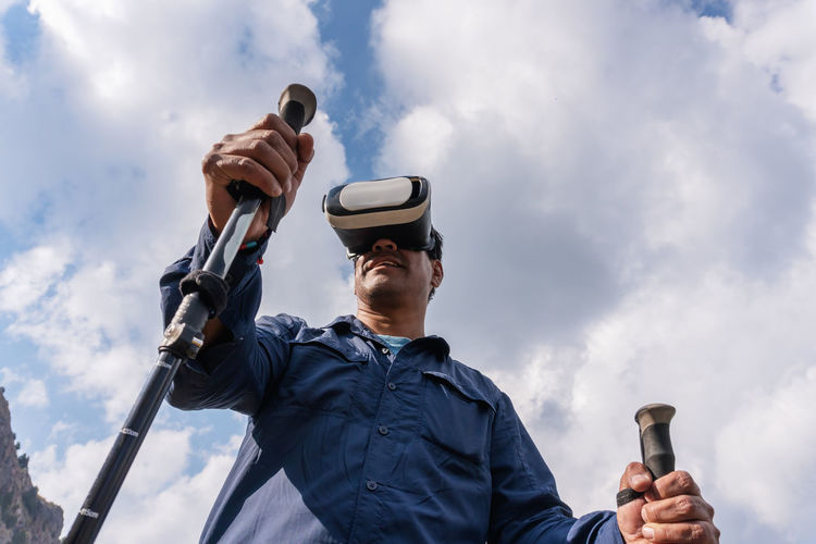 Low angle view of man wearing virtual reality headset