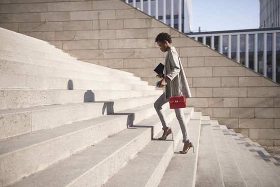 Woman walking on staircase in city