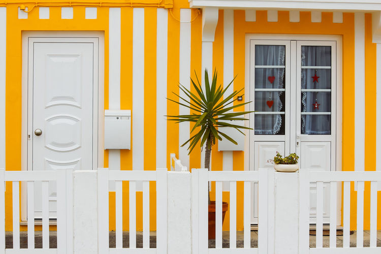 Typical yellow houses in costa nova - aveiro against sky