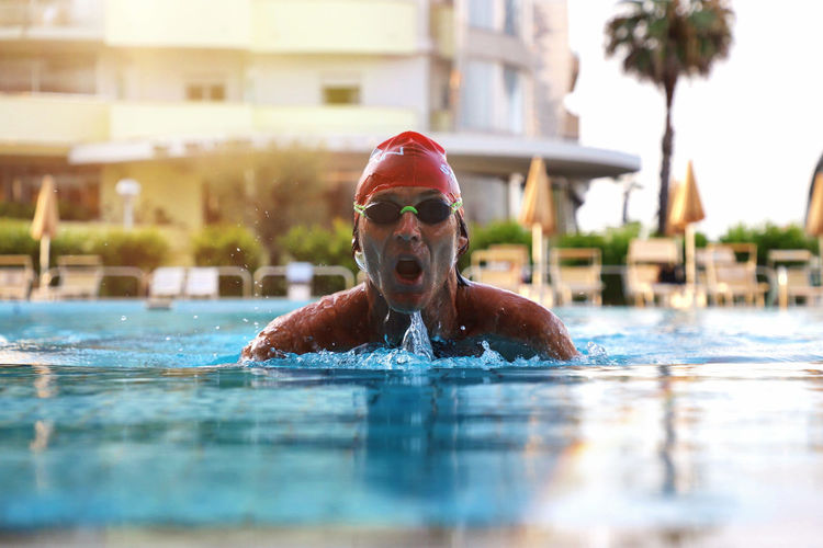 Portrait of man swimming in pool