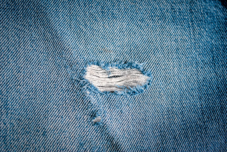 Close-up of hole in jeans