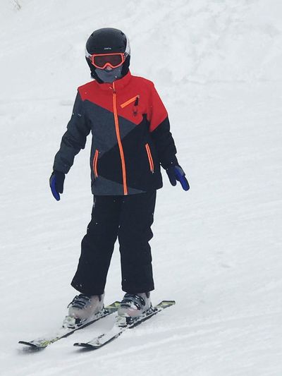 Full length of boy skiing