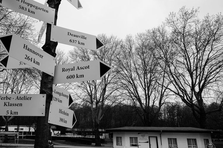 Low angle view of sign board against sky