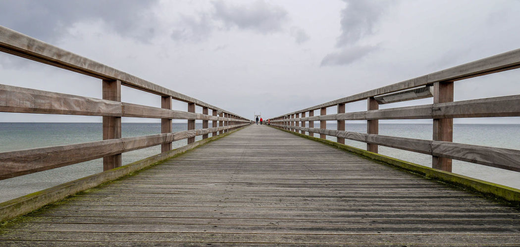 Pier on sea against sky