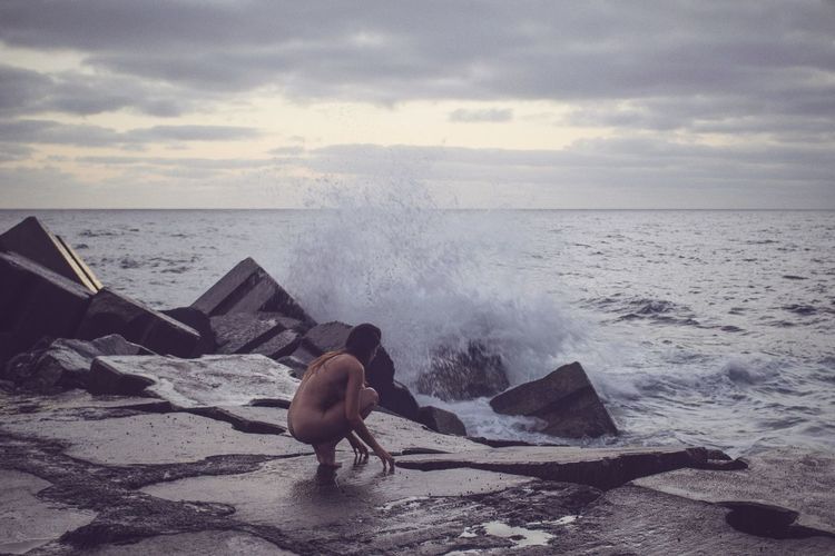 Naked woman on seashore