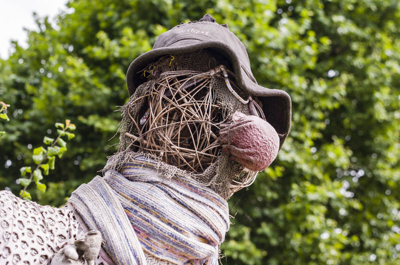 Low angle view of scarecrow against trees