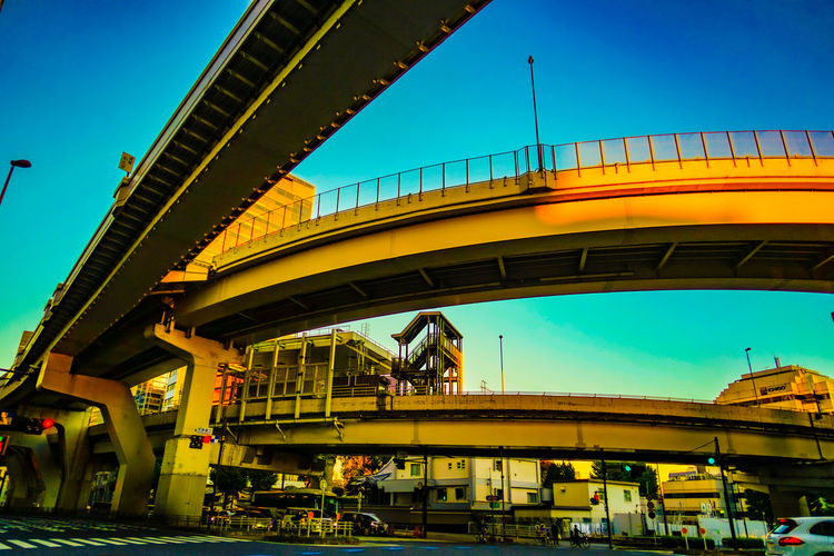 Illuminated bridge against sky at night