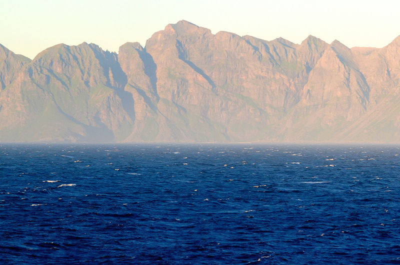 Scenic view of sea with mountains in background