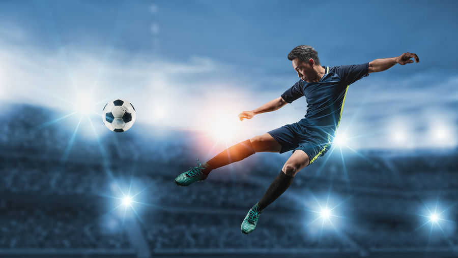 Low angle view of man playing soccer ball