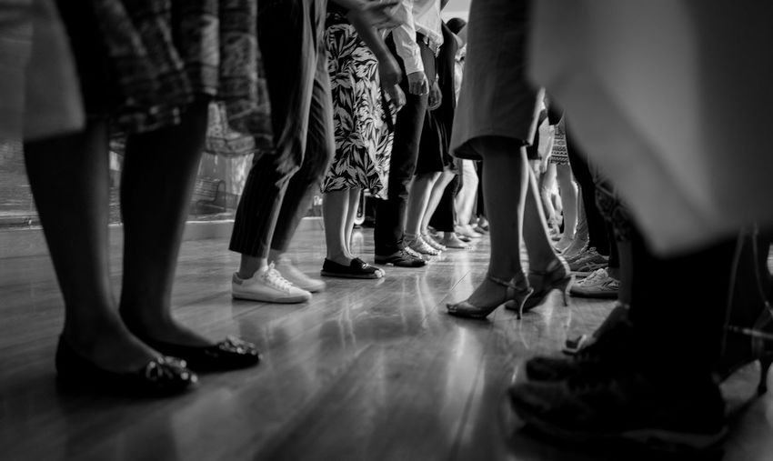 Low section of men and women standing on floor