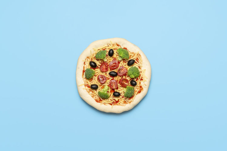 Directly above shot of pizza against blue background