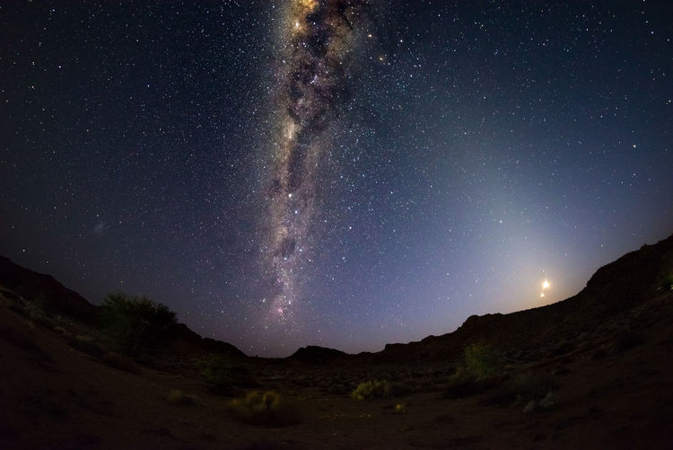 Scenic view of mountains against star field at night