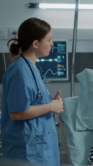 Side view of nurse standing at hospital
