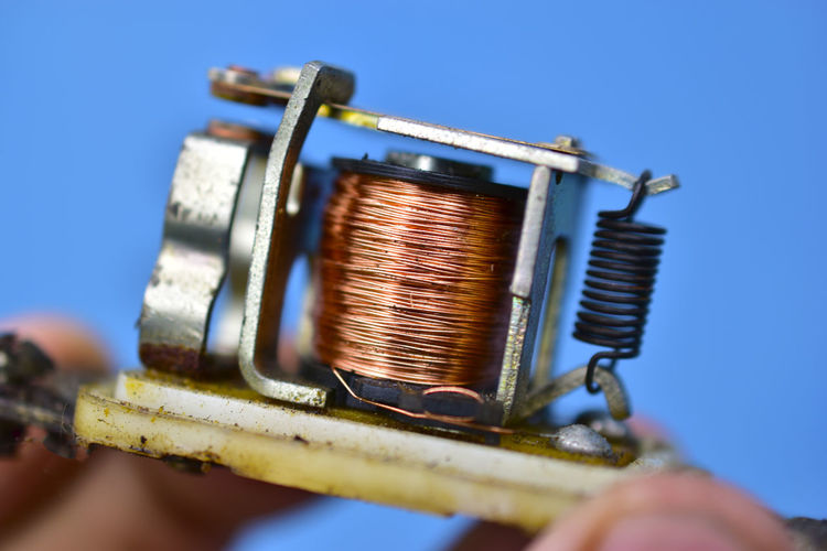 Copper coil switch in the hands of a master