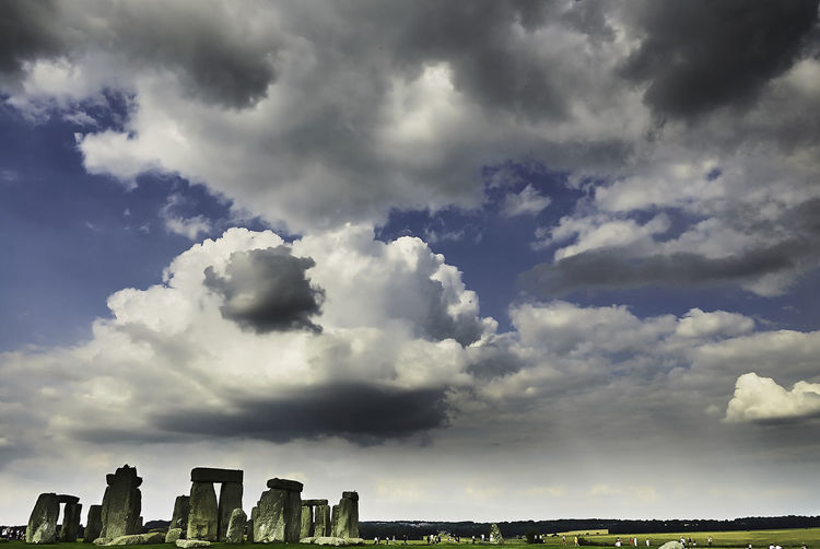 Rocks at stonehenge against cloudy sky