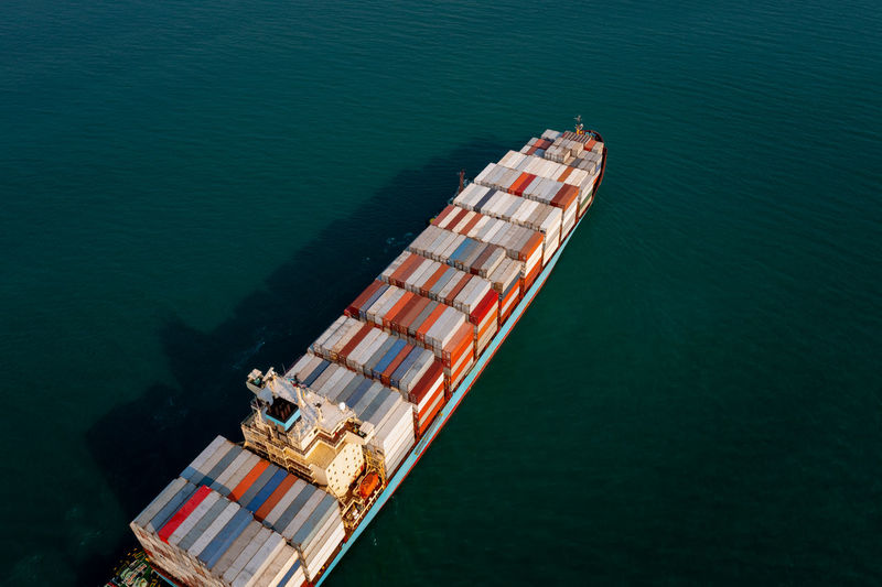 Aerial view container cargo ship large floating carrying commercial container in import export