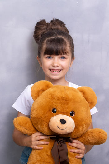 Portrait of cute girl with teddy bear