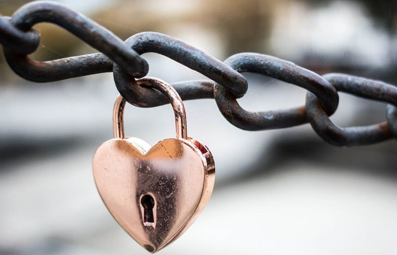 Close-up of padlock on heart shape chain
