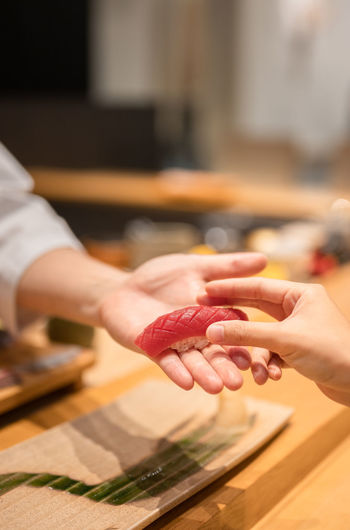 Cropped hands of person preparing food