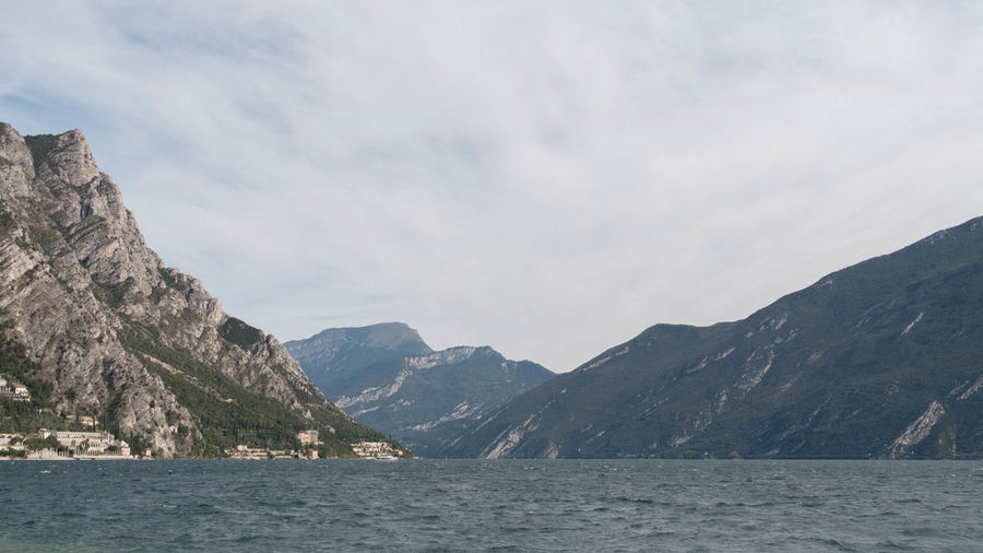 Scenic view of sea and mountains against sky