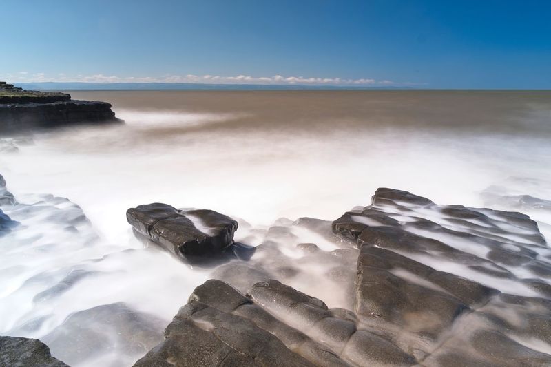 Scenic view of sea against blue sky. long exposure.